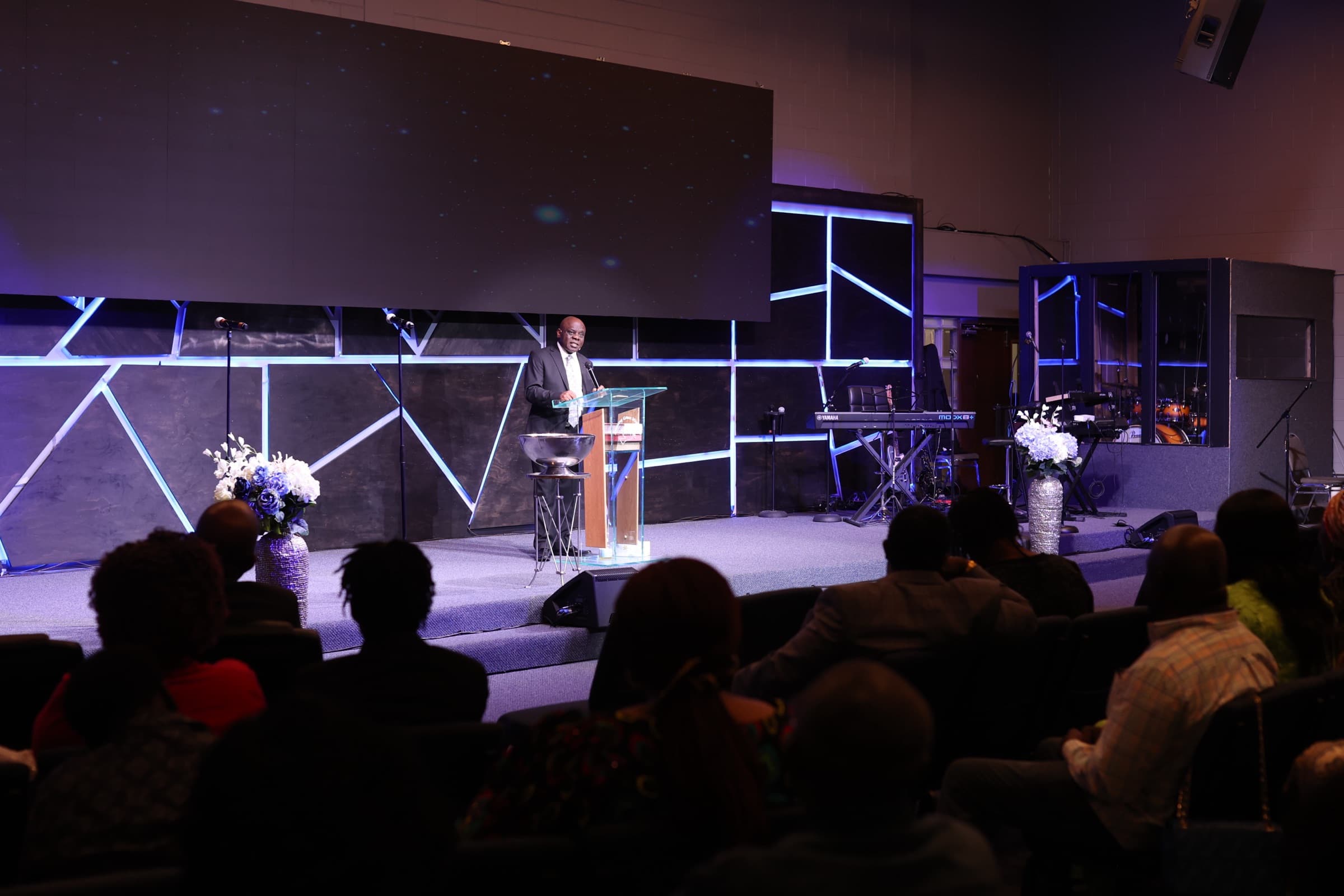 Pastor Nnaemeka Uchegbu preaching from the pulpit during a service