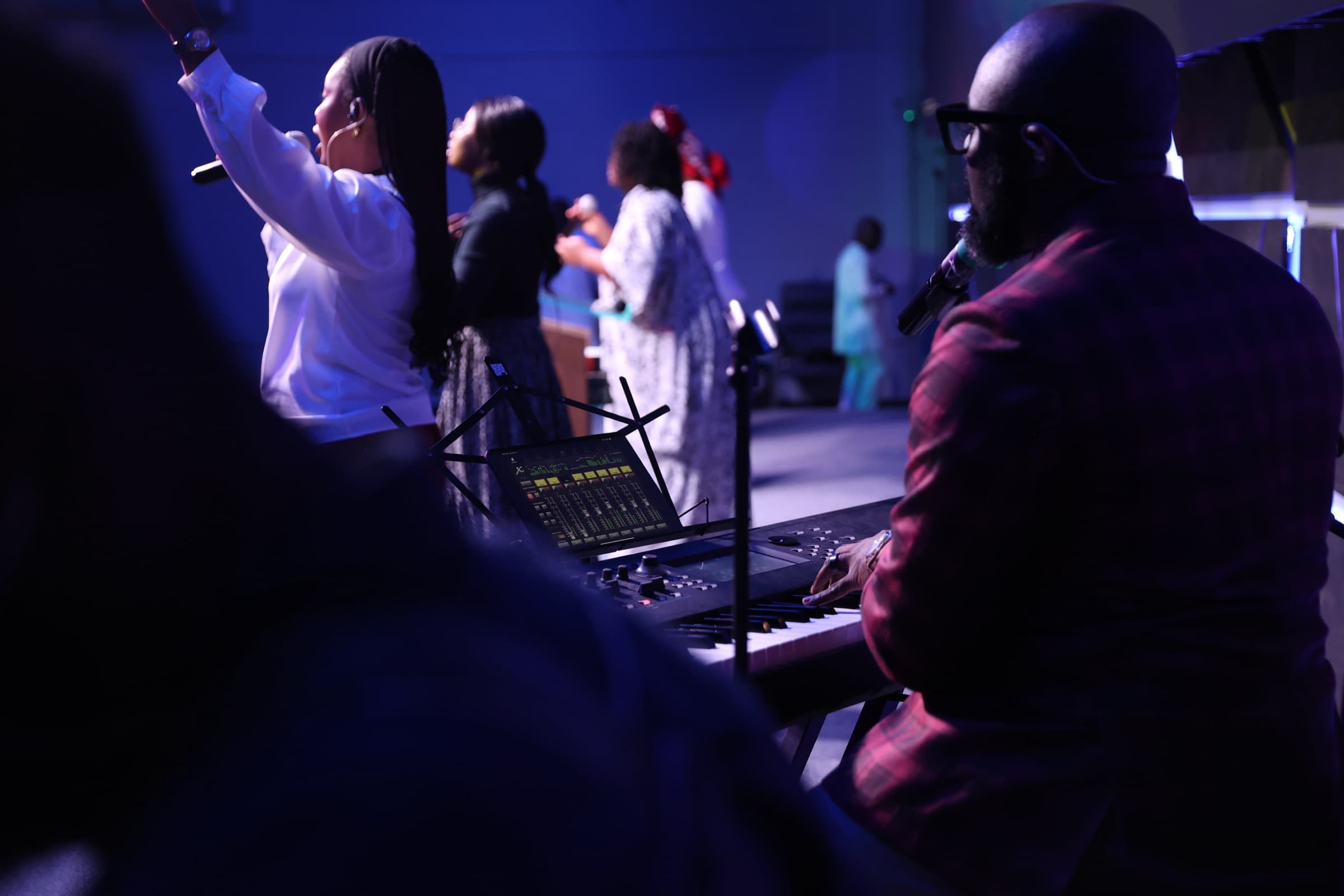 Hands playing the keyboard during worship at Amazing Grace Ministries